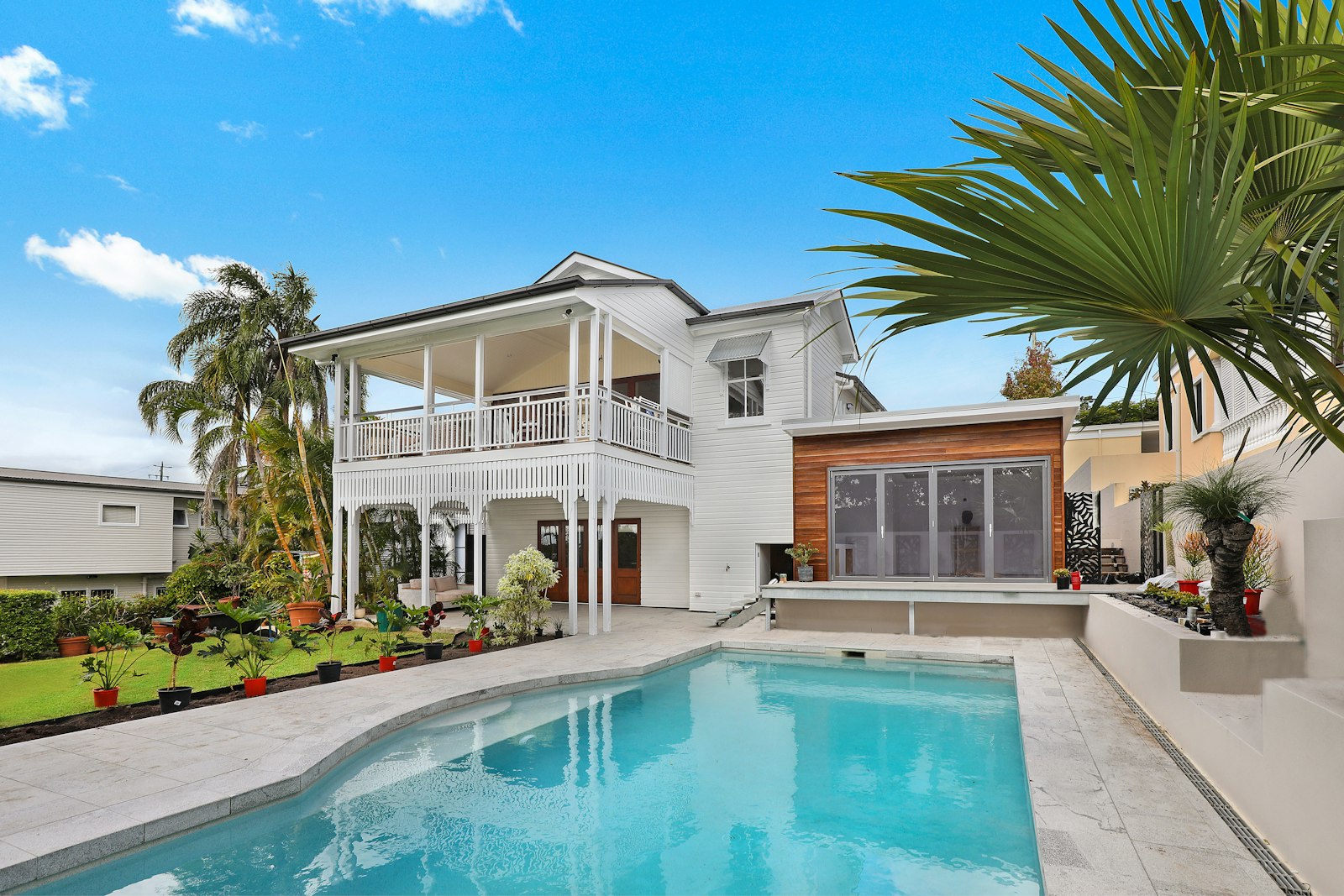 Beautiful home with artificial turf front yard showing how synthetic grass increases home value and curb appeal