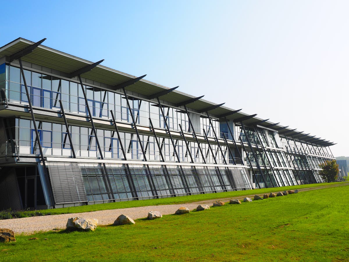 Lush green artificial turf landscaping surrounding a modern commercial building