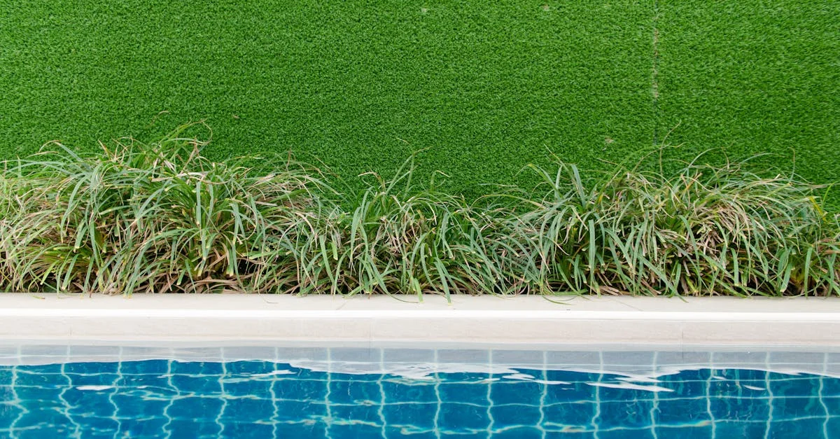 Well-maintained synthetic turf lawn beside a pool in a residential backyard